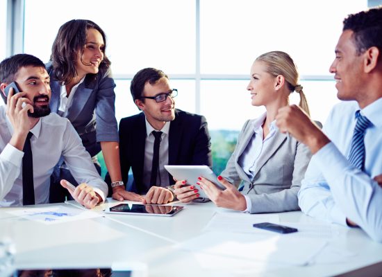 Happy co-workers discussing ideas in office